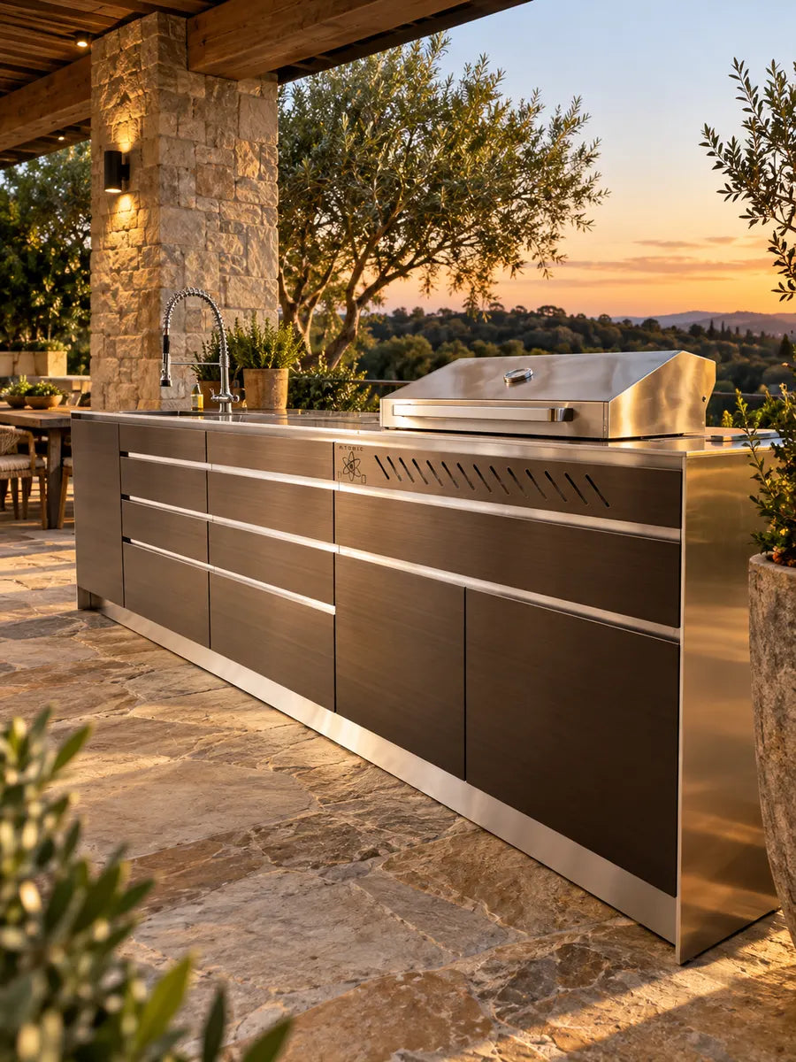 Dark bronze outdoor kitchen with stainless BBQ on a sandstone paved terrace