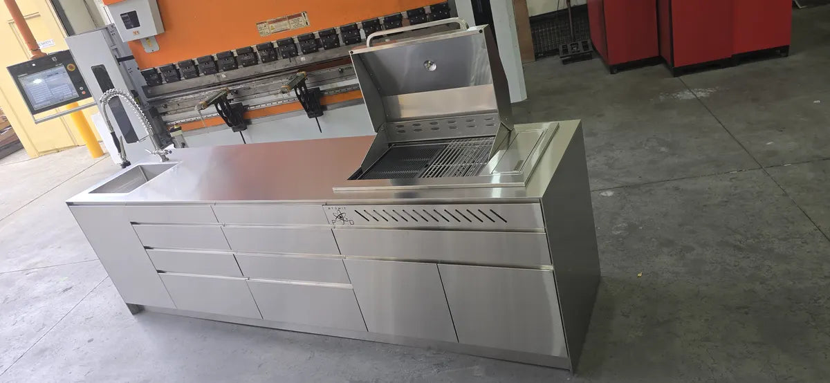 Stainless steel outdoor kitchen with BBQ beside the press brake in the Atomic PVD factory