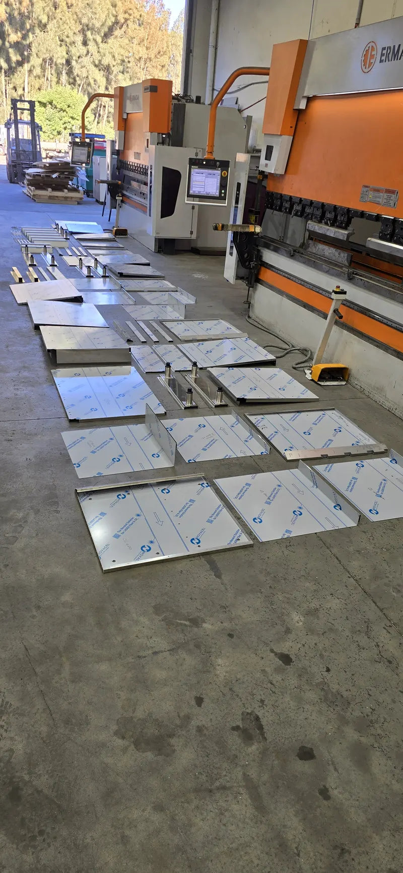 Laser cut stainless steel panels laid out for outdoor kitchen fabrication